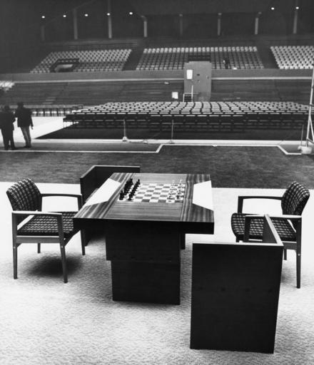 FILE - In this July 4, 1972 file photo, the chess table and chairs that would be used the following month by Bobby Fischer and Boris Spassky for their historic Match of the Century, tournament are seen in the vast Laugardalsholl Hall in Reykjavik, Iceland. The chess board, made of stone, would eventually be replaced mid-championship with a wood board for games 7 through 21 at the insistance of Fischer, who won the world chess champion. (AP Photo/Johann, File)