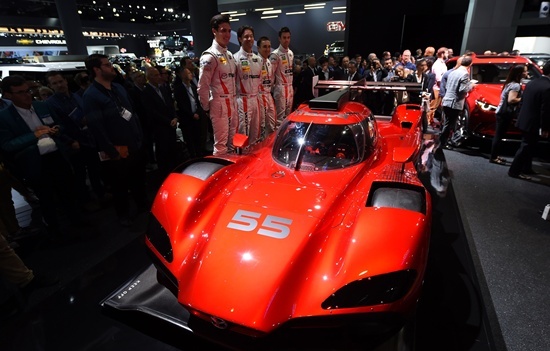 Los Angeles, California: Racing team members unveils the Mazda RT24-P DPi challenger racing car at the Mazda press conference during media preview days ahead of the public opening of the Los Angeles Auto Show, in Los Angeles, California, November 16, 2016. The LA Auto Show is open to the public from November 18 through November 27. AFP/Robyn Beck