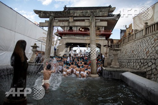 In this picture taken on February 18, 2017, Japanese boys step out of the fountain after being purified during the boys event in the annual Naked Man Festival or Hadaka Matsuriat Saidaiji Temple in Okayama, western Japan. Behrouz MEHRI / AFP