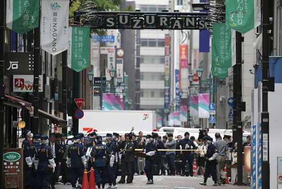 Tokyo: Police officers investigate the scene of a robbery at the Ginza shopping district in Tokyo on April 21, 2017. AFP/Jiji Press/STR