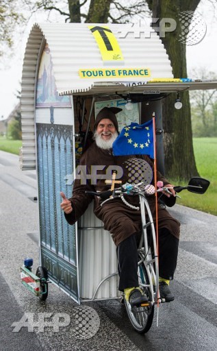 German bicycle enthousiast Dieter Didi Senft presents his latest creation, a self-designed Luther-Mobil, on a road near Sieversdorf, northeastern Germany, on May 4, 2017. Patrick Pleul/dpa/AFP