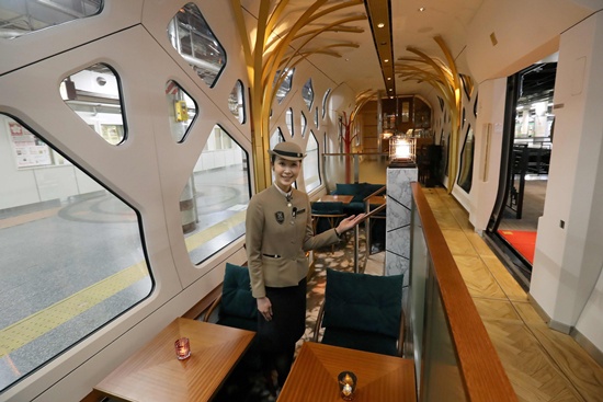 Tokyo: This picture taken on March 16, 2017 shows a crew member gesturing in the lounge car of the Train Suite Shiki-shima, operated by East Japan Railway, in Tokyo during a press preview. AFP/Jiji Press/str
