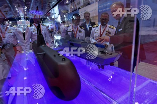 A scale model of the Type-218SG submarine (L) is displayed at 11th International Maritime Defence Exhibition and Conference (IMDEX) Asia in Singapore on May 16, 2017. ROSLAN RAHMAN / AFP