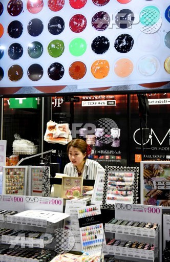 A nail artist exhibits her technique to visitors during the Tokyo Nail Forumn in Tokyo on May 16, 2017. Toru Yamanaka/AFP
