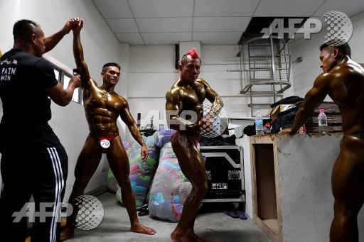 Bodybuilder Mohamad Hakimi (2nd R) poses backstage during the Mr. Malaysia 2017 bodybuilding competition in Puchong, outside Kuala Lumpur, on May 21, 2017. Manan Vatsyayana/AFP