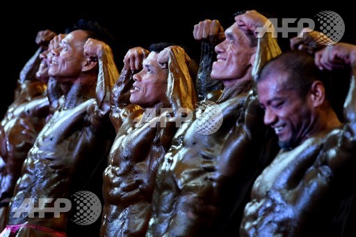 Bodybuilders perform onstage during the Mr. Malaysia 2017 bodybuilding competition in Puchong, outside Kuala Lumpur, on May 21, 2017. Manan Vatsyayana/AFP