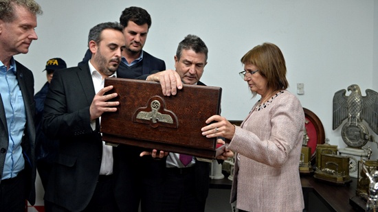 Argentinas Security Minister Patricia Bullrich (R) looks at Nazi artifacts seized in the house of an art collector in Buenos Aires, in this undated handout released on June 20, 2017. Courtesy of the Argentine Ministry of Security/Handout via REUTERS