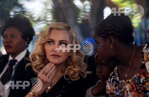 US pop star Madonna looks one inside the Mercy James Centre during the opening ceremony at Queen Elizabeth Hospital in Malawis Commercial City of Blantyre on July 11, 2017. Madonna took her four adopted Malawian children to the opening of a paediatric hospital wing that her charity has built in their home country. Amos Gumulira/AFP