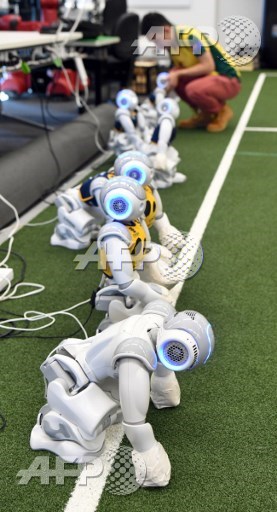 Victor Wong unplugs a soccer robot in Sydney on July 21, 2017, as Australia’s five-time world champions of robot soccer, the University of New South Wales (UNSW) Runswift team, heads to Japan this weekend to try and recapture the international trophy for a record sixth time, facing off against powerful teams from Germany and the USA. William West/AFP