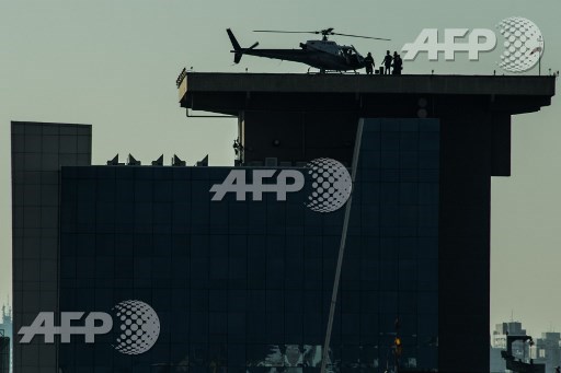 A helicopter lands on the roof of a building in downtown Sao Paulo, Brazil on June 23, 2017. Airbus subsidiary Voom gives an alternative for those willing to avoid Sao Paulos heavy car traffic, offering a helicopter service similar to the car service offered by Uber. Nelson Almeida/AFP