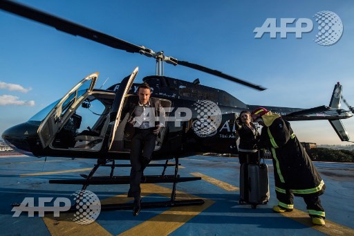 Brazilian businessman Gustavo Boyle disembarks from the helicopter upon arriving in Guarulhos, some 20 km from Sao Paulo, Brazil on June 23, 2017 Airbus subsidiary Voom gives an alternative for those willing to avoid Sao Paulos heavy car traffic, offering a helicopter service similar to the car service offered by Uber. Nelson Almeida/AFP