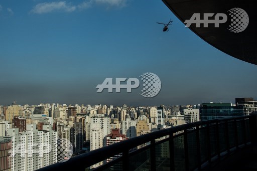 A helicopter overflies Sao Paulo, Brazil on June 23, 2017. Airbus subsidiary Voom gives an alternative for those willing to avoid Sao Paulos heavy car traffic, offering a helicopter service similar to the car service offered by Uber. Nelson Almeida/AFP
