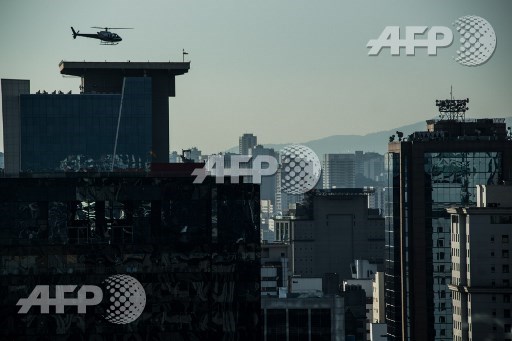 A helicopter lands on the roof of a building in downtown Sao Paulo, Brazil on June 23, 2017. Airbus subsidiary Voom gives an alternative for those willing to avoid Sao Paulos heavy car traffic, offering a helicopter service similar to the car service offered by Uber. Nelson Almeida/AFP