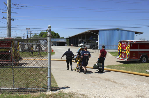 In this photo provide by the Bryan, Texas Fire Department, taken April 29, 2014, Bryan Texas firefighters transport injured worker in a stretcher to the ambulance. An explosion at the Bryan Texas Utilities Power Plant left a 60-year-old employee dead and two injured. (Bryan, Texas Fire Department via AP)