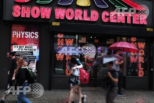 NEW YORK, NY: Pedestrians walk by one of the few remaining adult DVD stores in Times Square on August 7, 2017 in New York City. Spencer Platt/Getty Images/AFP 