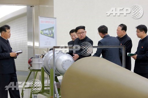 This undated picture released by North Koreas official Korean Central News Agency (KCNA) on September 3, 2017 shows North Korean leader Kim Jong-Un (C) looking at a metal casing with two bulges at an undisclosed location. North Korea has developed a hydrogen bomb which can be loaded into the countrys new intercontinental ballistic missile, the official Korean Central News Agency claimed on September 3. Questions remain over whether nuclear-armed Pyongyang has successfully miniaturised its weapons, and whether it has a working H-bomb, but KCNA said that leader Kim Jong-Un had inspected such a device at the Nuclear Weapons Institute. STR/KCNA via KNS/AFP