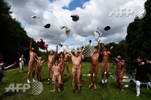 Naked people throw their clothes up in the air at a newly opened space for naturists at the Bois de Vincennes park in Paris on August 31, 2017. The space will be open daily until October 15th. Bertrand Guay/AFP