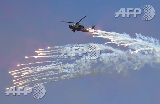 A South Korean Navy Lynx helicopter fires flares during a commemoration ceremony marking South Koreas Armed Forces Day, which will fall on October 1, at the Second Fleet Command of Navy in Pyeongtaek on September 28, 2017. Jung Yeon-Je/Pool/AFP