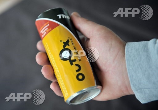 (FILES) This file photo taken on June 18, 2010 shows a man holding a can of Outox, a drink supposed to decrease alcohol in the blood, during a press conference in Paris. The case concerning the manufacturer of soda Outox, a supposedly sobering drink that had caused controversy on the French market since its launch in 2010, is to be deliberated on October 3, 2017 in Versaille. Betrand Langlois/AFP