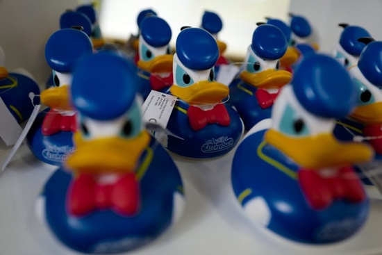 A picture taken on November 6, 2017 shows Donald Duck figurines displayed at a temporary shop set up in Berlin to mark the 50th anniversary of Donald Duck pocket books, called Lustiges Taschenbuch in German) and featuring Disney comics. John MacDougall/AFP