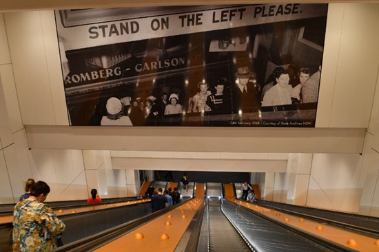 People take modern escalators, which have replaced the old wooden escalators of Wynyard railway station, in Sydney on December 7, 2017. Saeed Khan/AFP