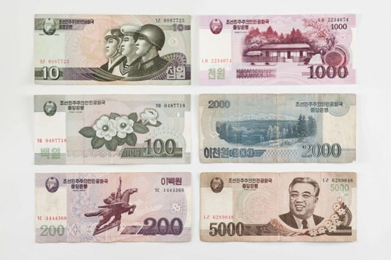 This photo illustration shows a selection of North Korean currency bank notes issued by Pyongyang, displayed in Seoul on January 4, 2018. Ed Jones/AFP