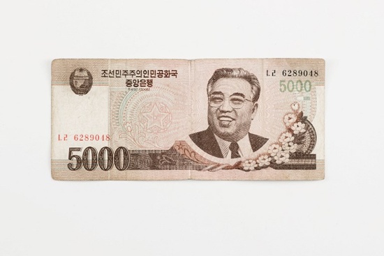This photo illustration shows a North Korean 5,000 won currency bank note issued by Pyongyang, displayed in Seoul on January 4, 2018. Ed Jones/AFP