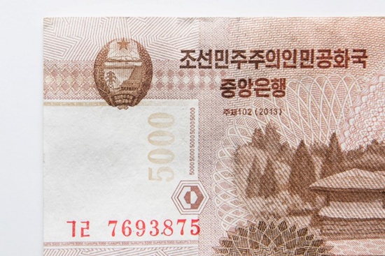 This photo illustration shows a detail view of a North Korean 5,000 won currency bank note issued by Pyongyang and displayed in Seoul on January 4, 2018. Ed Jones/AFP
