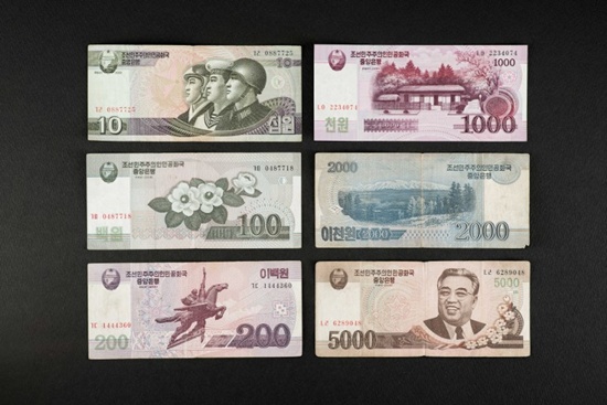 This photo illustration shows a selection of North Korean currency bank notes issued by Pyongyang, displayed in Seoul on January 4, 2018. Ed Jones/AFP