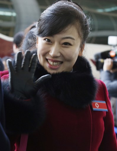 A member of the North Korean cheerleading squad waves as she arrives at the inter-Korea transit office to leave for North Korea after attending the Pyeongchang 2018 Winter Olympic Games, in Paju near the Demilitarized Zone on February 26, 2018. Kim Hee-Chul/Pool/AFP