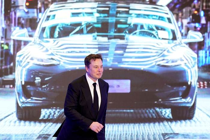 อีลอน มัสก์ ซีอีโอ Tesla Inc กำลังเดินผ่านหน้าจอแสดงภาพ Tesla Model 3 ระหว่างวงพิธีเปิดตัวโครงการผลิตรถ รุ่น Model Y ที่โรงงานเทสลาในเซี่ยงไฮ้ ภาพวันที่ 7 ม.ค. 2020 (แฟ้มภาพรอยเตอร์ส) 