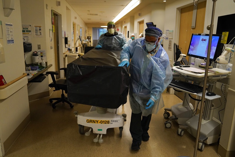 (ภาพถ่ายเมื่อ 9 ม.ค. 2021) พนักงานเข็นเตียงวางร่างคนไข้โควิด-19 ที่เสียชีวิต ณ โรงพยาบาลศูนย์การแพทย์โพรวิเดนซ์ โฮลี คลอส ในเมืองลองแองเจลิส รัฐแคลิฟอร์เนีย สหรัฐอเมริกา