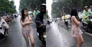 สังคมงวยงง.. สาวปริศนาเดินลุยฝนเดียวดายห่มน้อยฮานอยไร้น้ำใจ