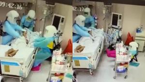 เผยนาที! พยาบาลสาวในชุด PPE  ล้มหงาย หลังช่วยผู้ป่วยโควิดพลิกตัว (ชมคลิป)